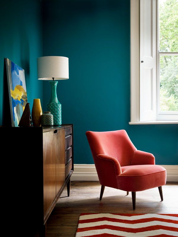 Teal living room with coral pink velvet chair