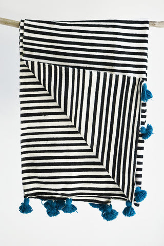 Black and white stripe blanket: Blue pom poms