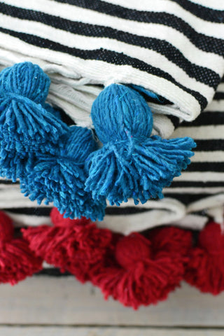 Black and white stripe blanket: Blue pom poms
