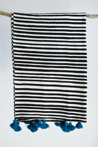 Black and white stripe blanket: Blue pom poms