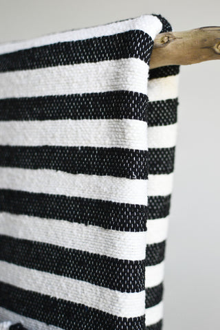 Black and white stripe blanket: Blue pom poms