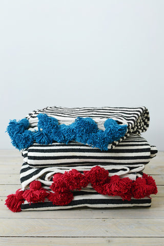 Black and white stripe blanket: Blue pom poms